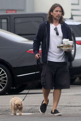 A Surprising Sight Oscar Winner Carries a Tray of Coffee While Walking His Little Dog  Stars with Their Pets in 2023